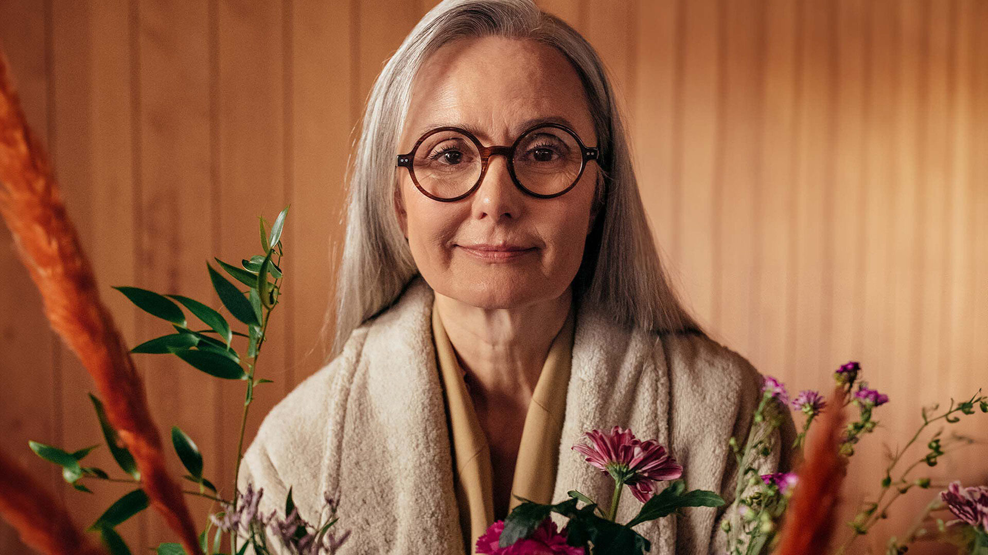 Woman with eye glasses smiling to camera. 